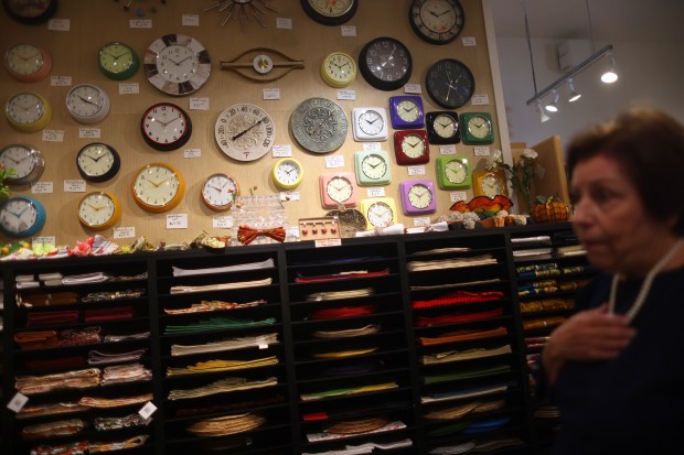 Clocks displayed for sale by Domus owner Margaret Smith, right,...