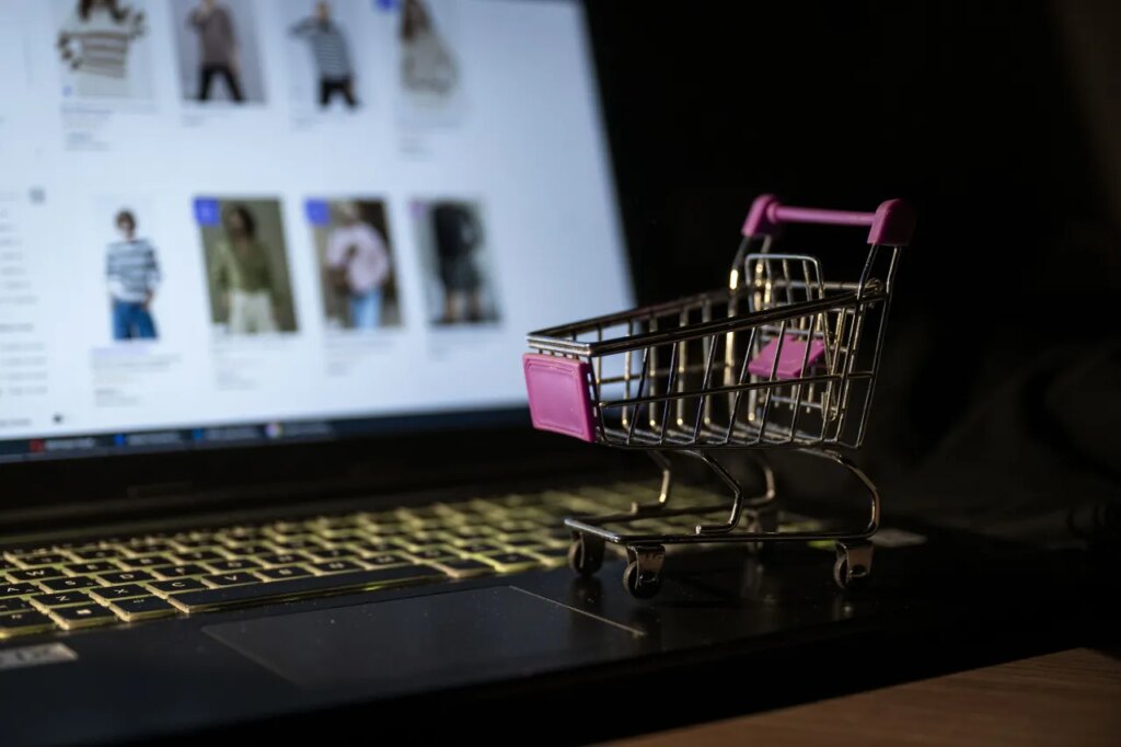 A miniature shopping cart is seen on a laptop with its screen displaying an online shopping website. ChatGPT has started e-commerce, powered by Etsy and Shopify. (Photo by Betul Abali/Anadolu via Getty Images)
