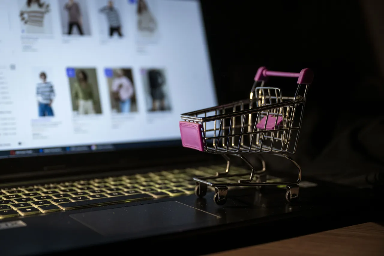 A miniature shopping cart is seen on a laptop with its screen displaying an online shopping website. ChatGPT has started e-commerce, powered by Etsy and Shopify. (Photo by Betul Abali/Anadolu via Getty Images)