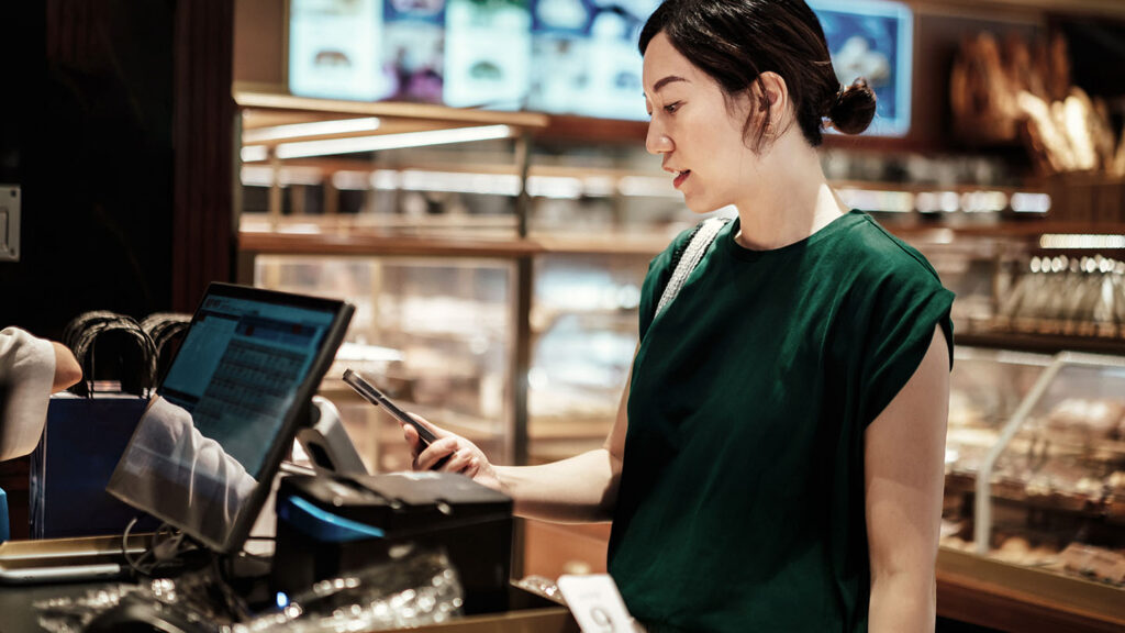 Woman paying with her phone banner