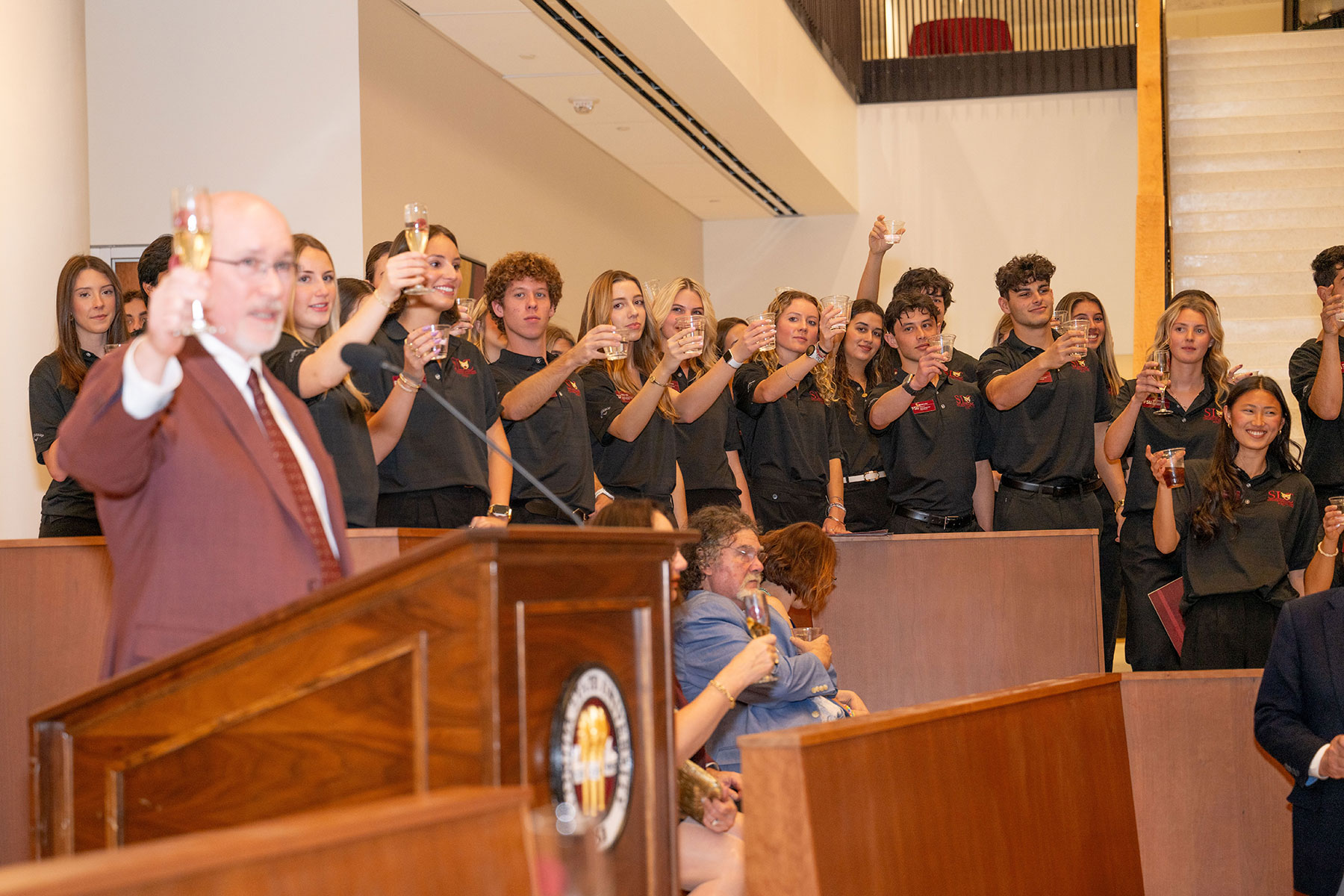 Michael Hartline, dean of the College of Business, leads Business Student Leadership Council members in a toast to Legacy Hall and to the friends and alumni who made it possible.