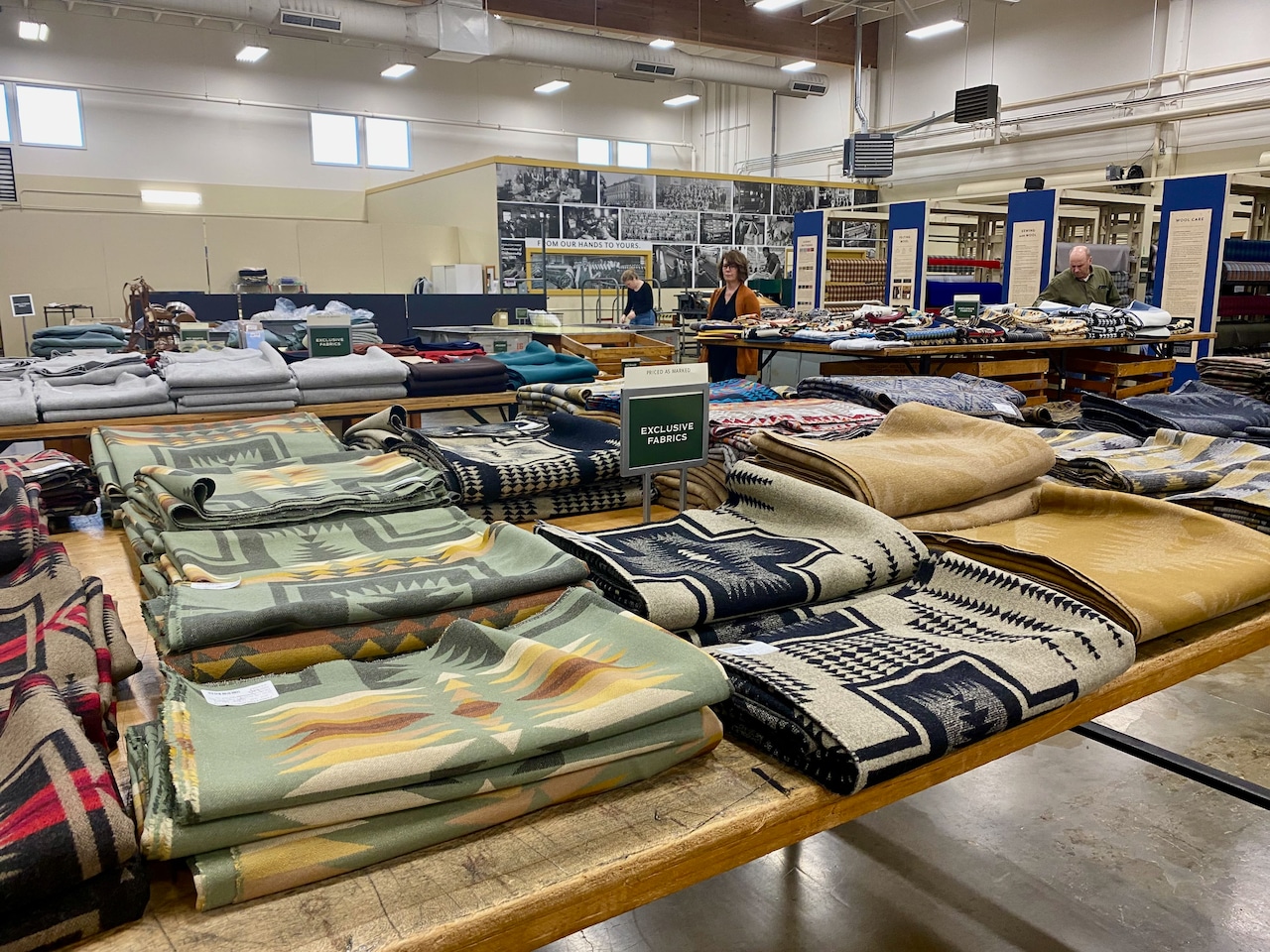 tables with selections of wool fabric inside a retail store