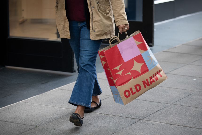 A shopper carries an Old Navy bag in San Francisco, California, on November 19, 2025.