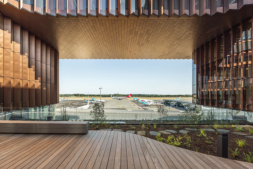 BIG's timber 'snakes' rise as skypark business center nears completion in luxembourg