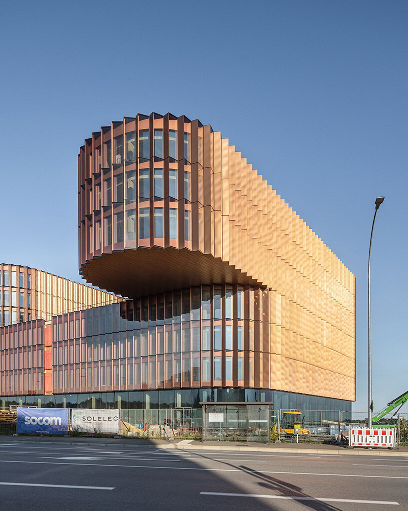 BIG's timber 'snakes' rise as skypark business center nears completion in luxembourg