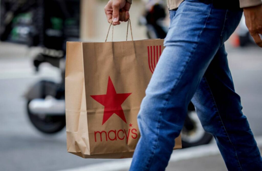 A shopper carries a Macy's bag through Union Square as retailers prepare for Black Friday in Sa ...
