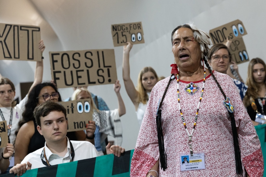 Members of civil society demonstrate in the corridors of COP30.