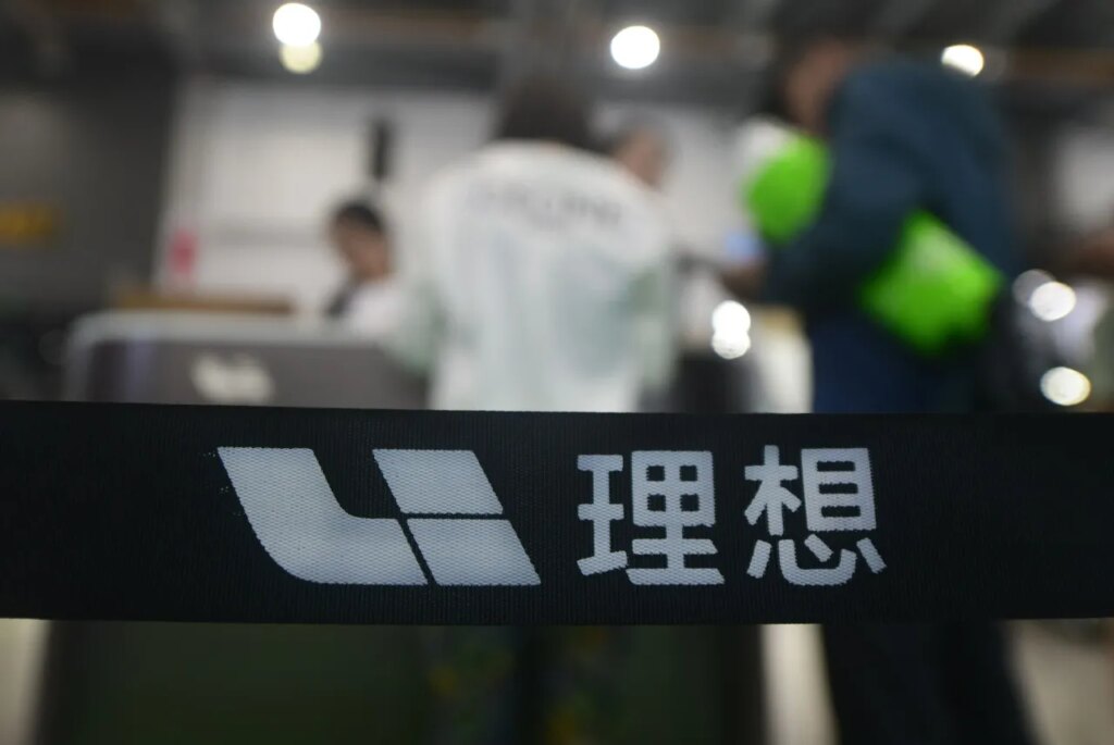 People stop by the booth of the Chinese carmaker Li Auto during an auto show in Hangzhou. (Photo credit should read LONG WEI / Feature China/Future Publishing via Getty Images)