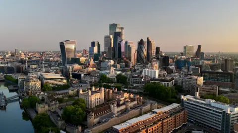 Reuters Day breaks over the City of London, with buildings visible including the Walkie Talkie and the Gherkin.