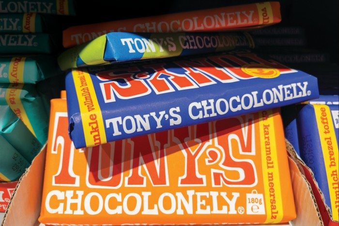 Stack of Tony’s Chocolonely chocolate bars in colourful wrappers on display