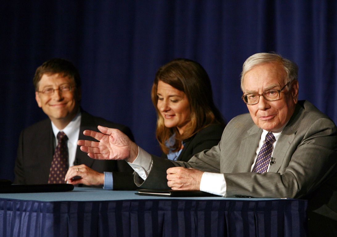 Warren Buffett speaks while Bill and Melinda Gates look on during a news conference in New York on June 26, 2006. Buffett had signed over much of his $44 billion fortune to the Bill and Melinda Gates Foundation, uniting two of world's richest people in a bid to fight disease, reduce poverty and improve education.