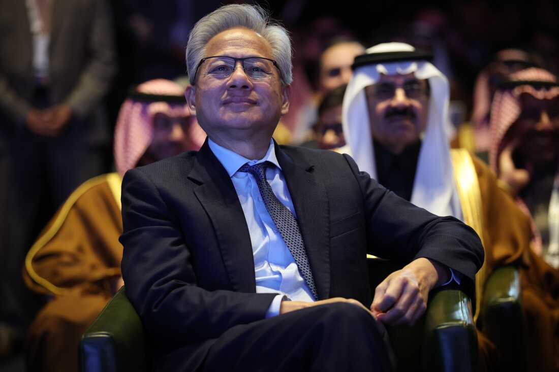 Nvidia CEO Jensen Huang listens as U.S. President Donald Trump speaks at the U.S.-Saudi Investment Forum in November in Washington, DC. Nvidia is the world's most valuable company, and has spent the year seeking the U.S. government's approval to sell one of its advanced semiconductor chips in China. (Photo by Win McNamee/Getty Images)