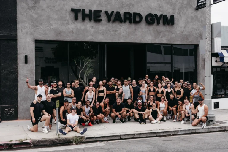 people line up for a photo outside of The Yard Gym