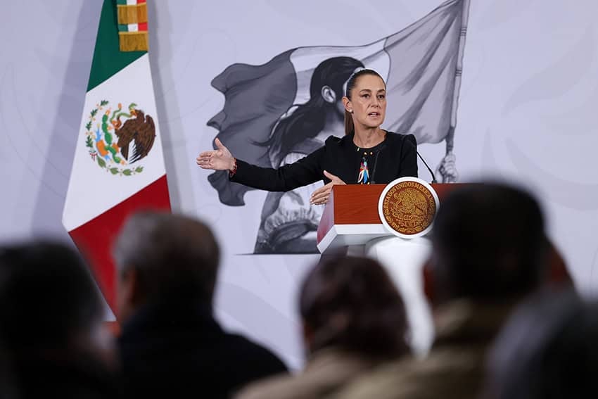President Sheinbaum gestures from the podium of her morning press conference