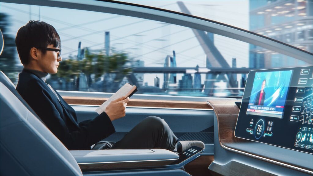 Person reading in an autonomous car.