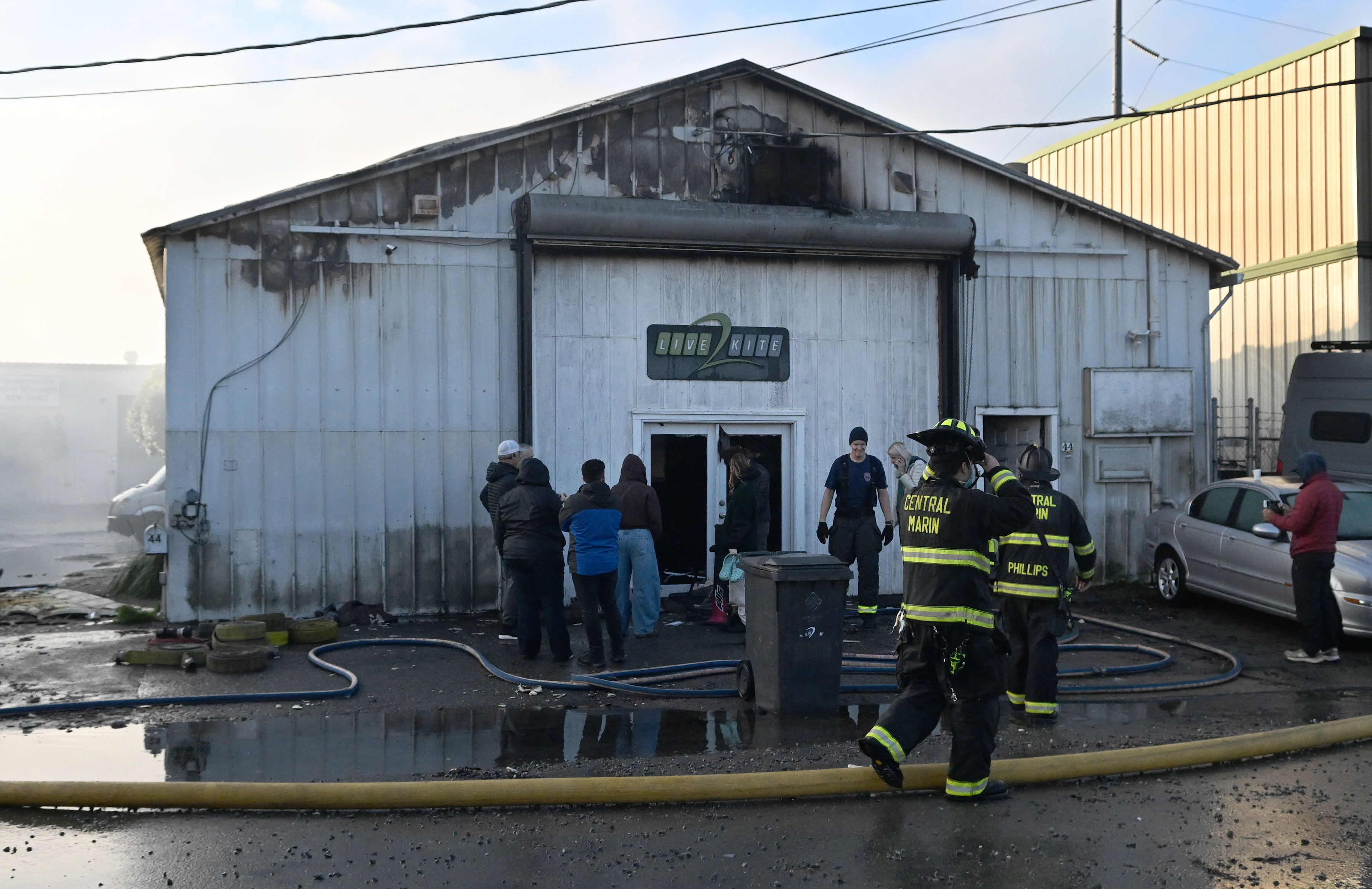 People gather outside as Central Marin firefighters work at the...