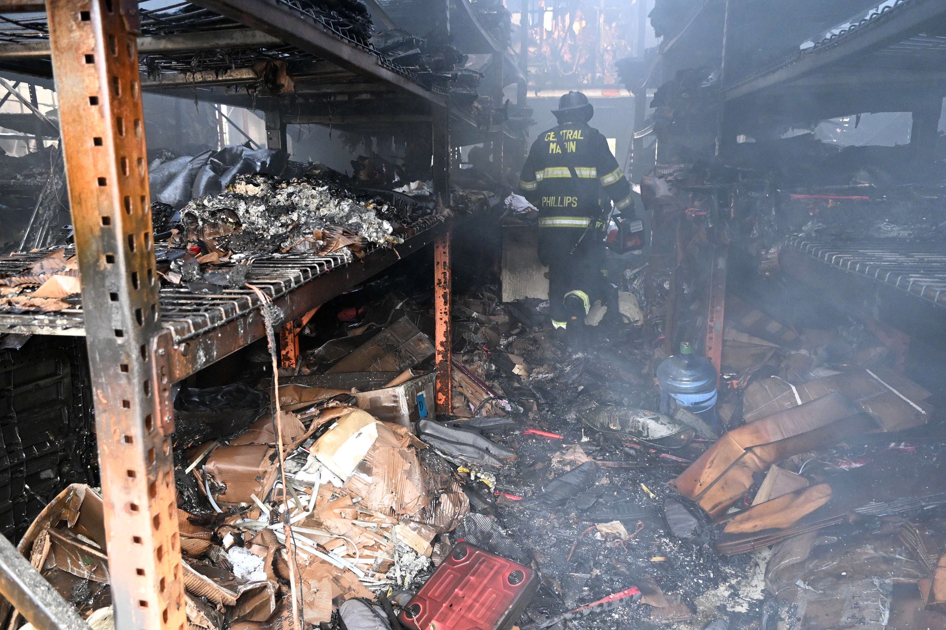 Smoke lingers inside as Central Marin firefighter Matt Phillips enters...