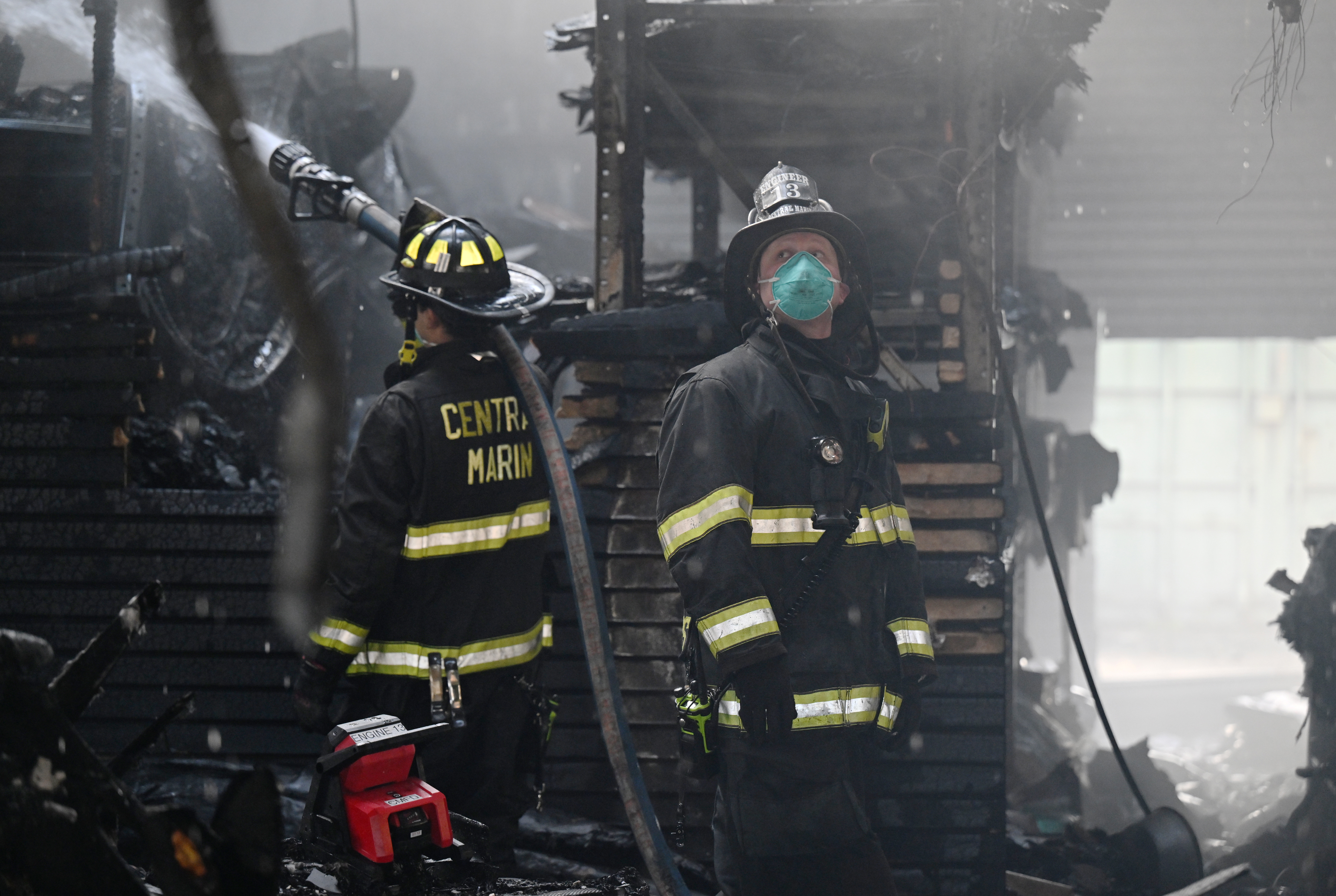 Central Marin firefighters Miles Grisman, left, and Matt Phillips work...