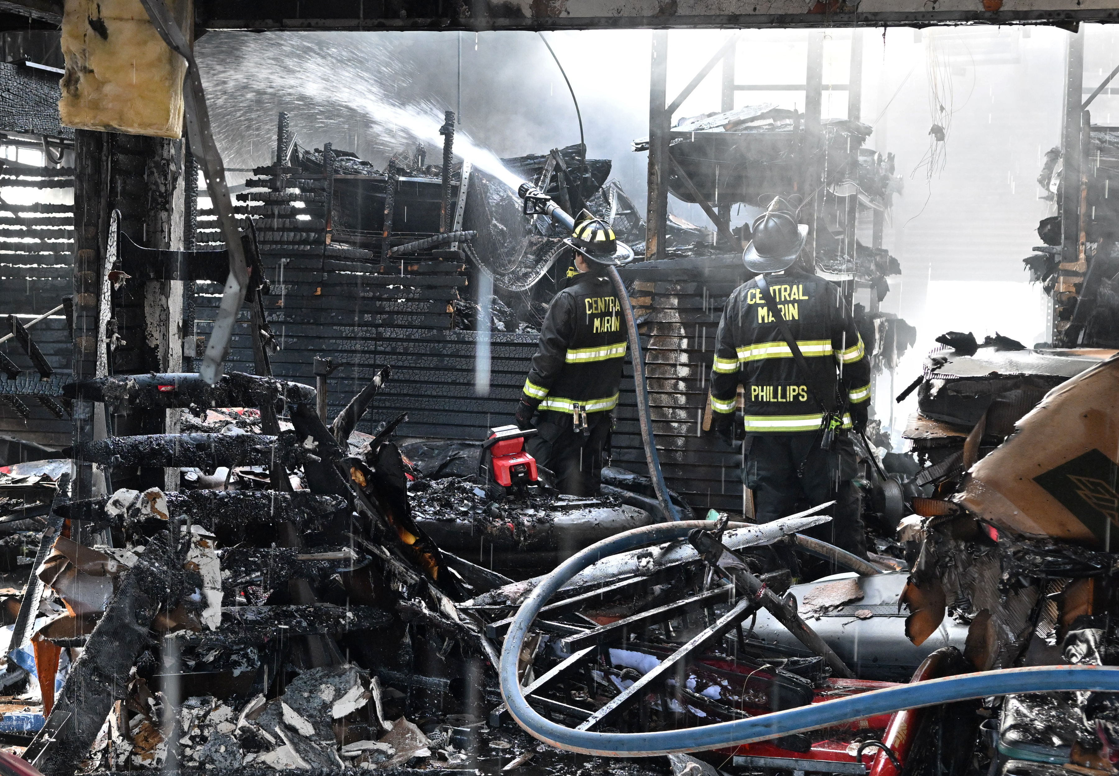 Central Marin firefighters Miles Grisman, left, and Matt Phillips work...