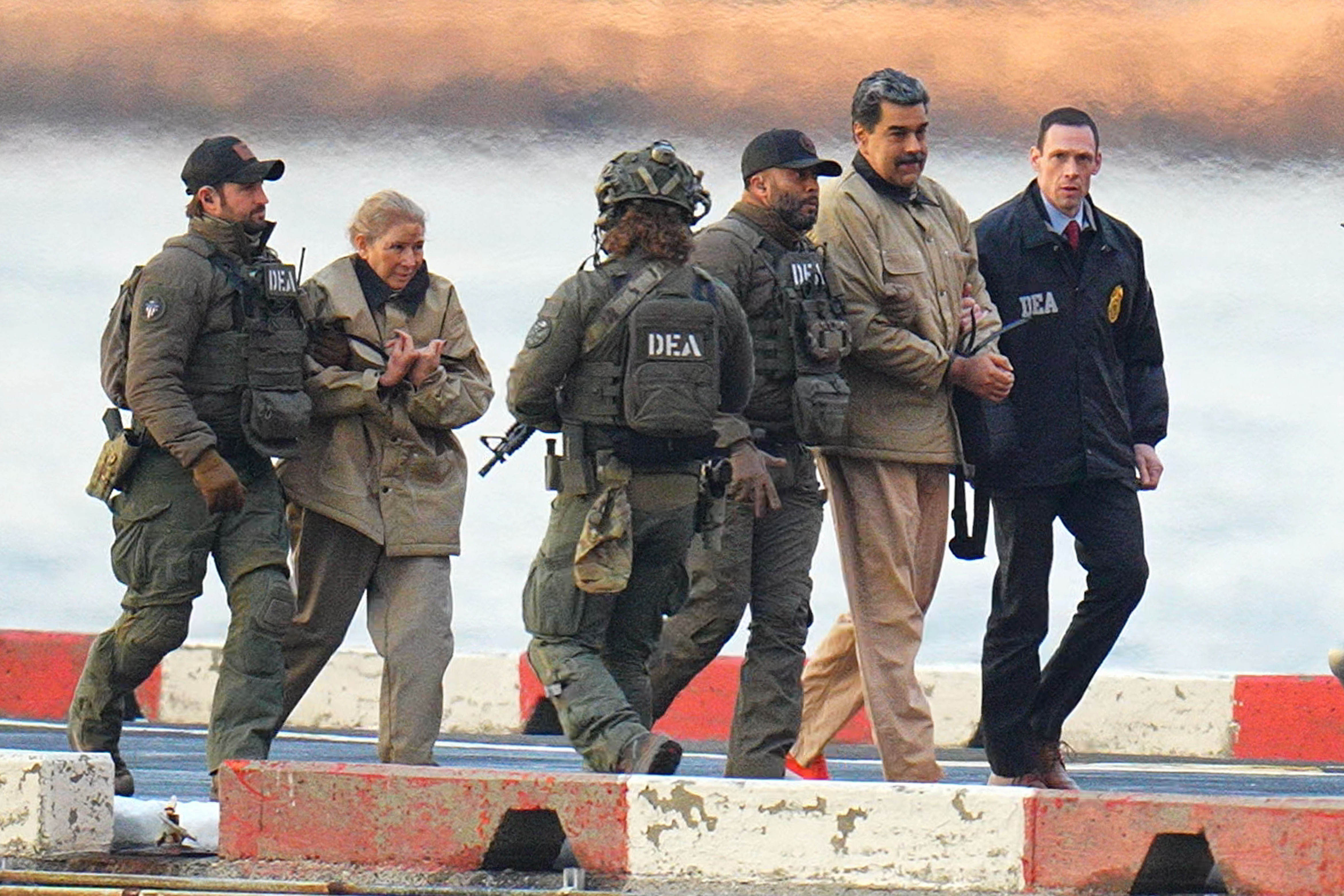 NEW YORK, NY - JANUARY 5: Nicolas Maduro and his wife, Cilia Flores, are seen in handcuffs after landing at a Manhattan helipad, escorted by heavily armed Federal agents as they make their way into an armored car en route to a Federal courthouse in Manhattan on January 5, 2026 in New York City. (Photo by XNY/Star Max/GC Images)