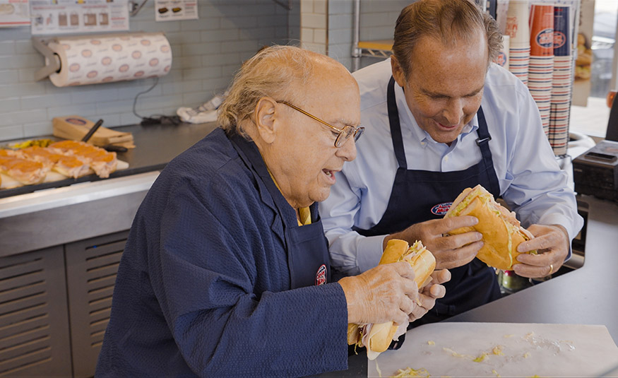Asbury Park native Danny DeVito – and New Jersey Hall of Fame Induction Ceremony host – helps inductee and Jersey Mike's founder Peter Cancro build a sub that DeVito says “tastes like home” as part of the ceremony broadcast.