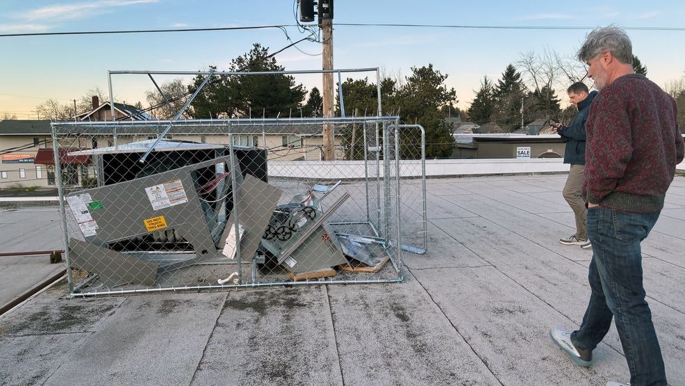 Brett Moore, president of Montavilla Sewing Centers, approaches a destroyed HVAC unit atop his businesses roof. Thieves have repeatedly stripped parts from the units at Moore's business. (Jennifer Singh/KATU)