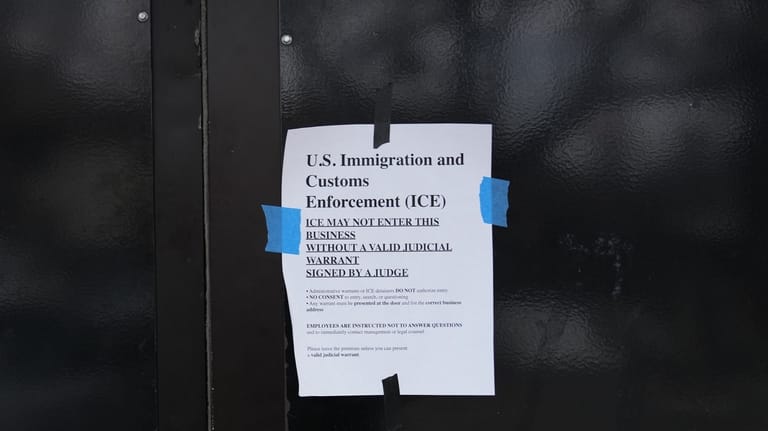 A sign is taped to the outside of the 24...