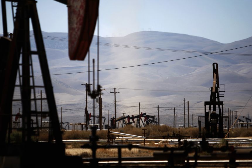 A dust devil blows across an oil field over the Monterey Shale formation where gas and oil extraction using hydraulic fracturing, or fracking, fed the recent boom in US oil production.
