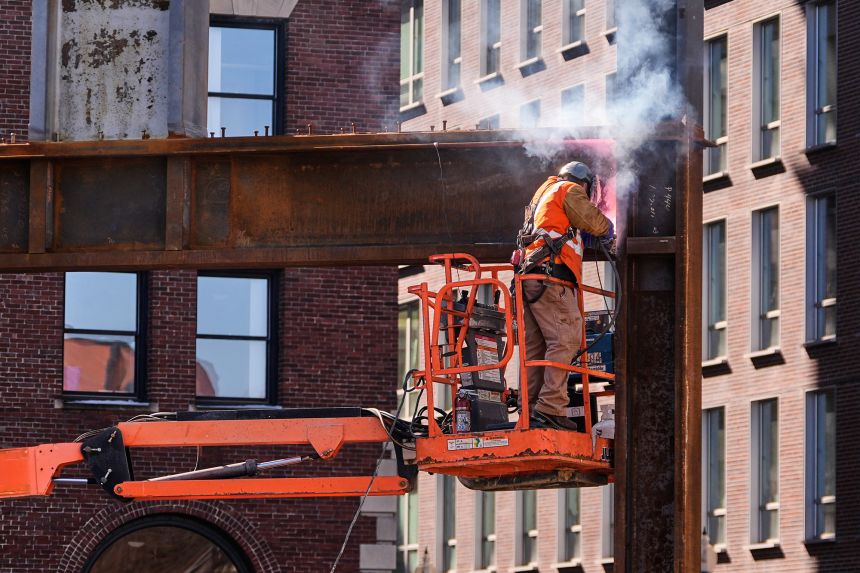 A construction worker welds a beam at a building under construction, on February 26, 2026, in Boston.