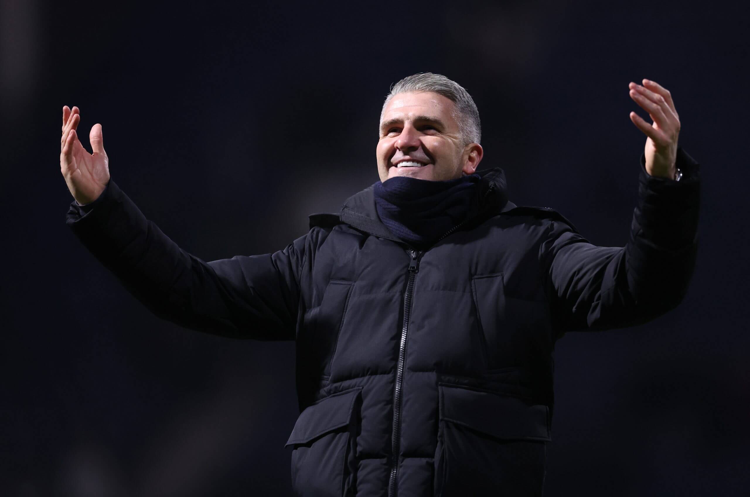A smiling Ryan Lowe celebrates with fans in happier times at Wigan Athletic