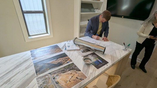 Lee Bowman of the Legion Company signs his name to a guest list that was placed within the South Creek time capsule alongside other items like photos of 95 Market's construction, the latest community publications, and a statement from the developers Beechwood Carolinas. (Photo by Brighton McConnell/Chapel Hill Media Group.)