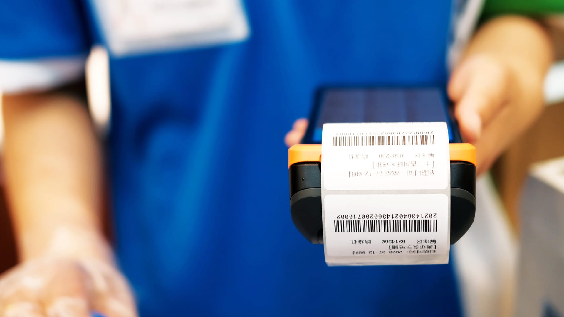 Photo shows a FamilyMart store staff member using Sunmi’s V2 Pro device in-store.