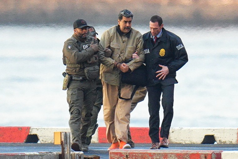 Nicolas Maduro, with zip-tied wrists, is escorted by DEA agents outside