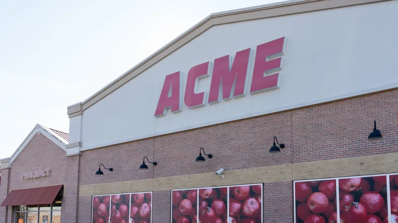 ACME store with brick exterior and images of apples in the windows