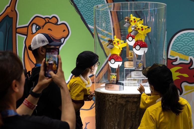 Spectators look at a display of Pokémon cards during the 2023 Pokémon World Championships at the Pacifico Yokohama in Japan.
